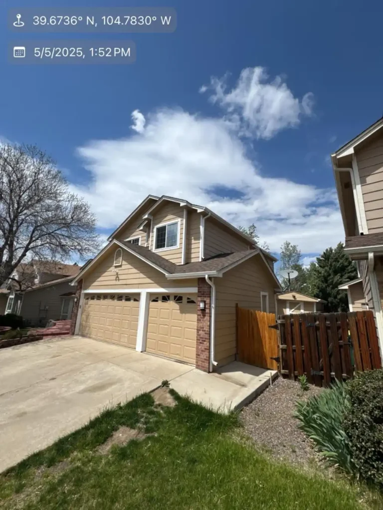 Residential Windsor rooftops with brown shingles surrounded by trees and blue sky